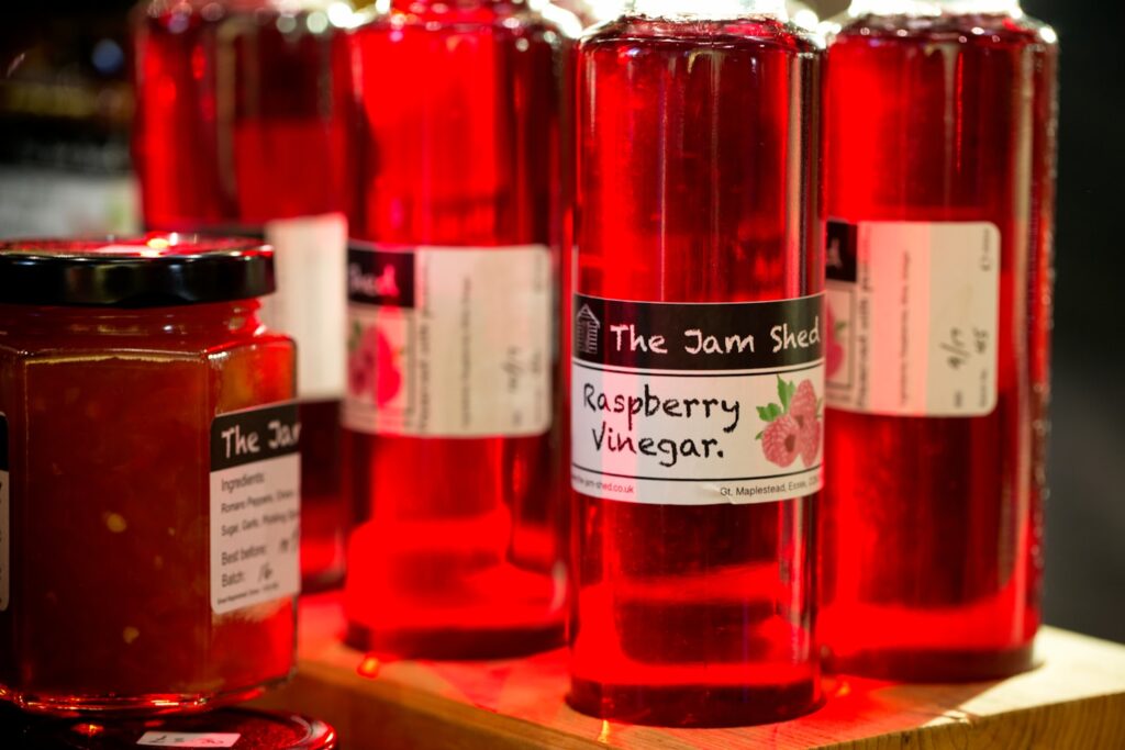 A table topped with lots of jars of liquid